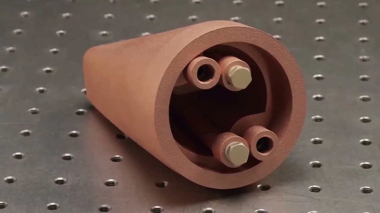Copper LPBF component with integrated internal passages on an inspection table